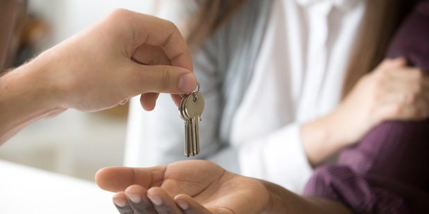 Realtor giving african customer keys, couple buying new house, c